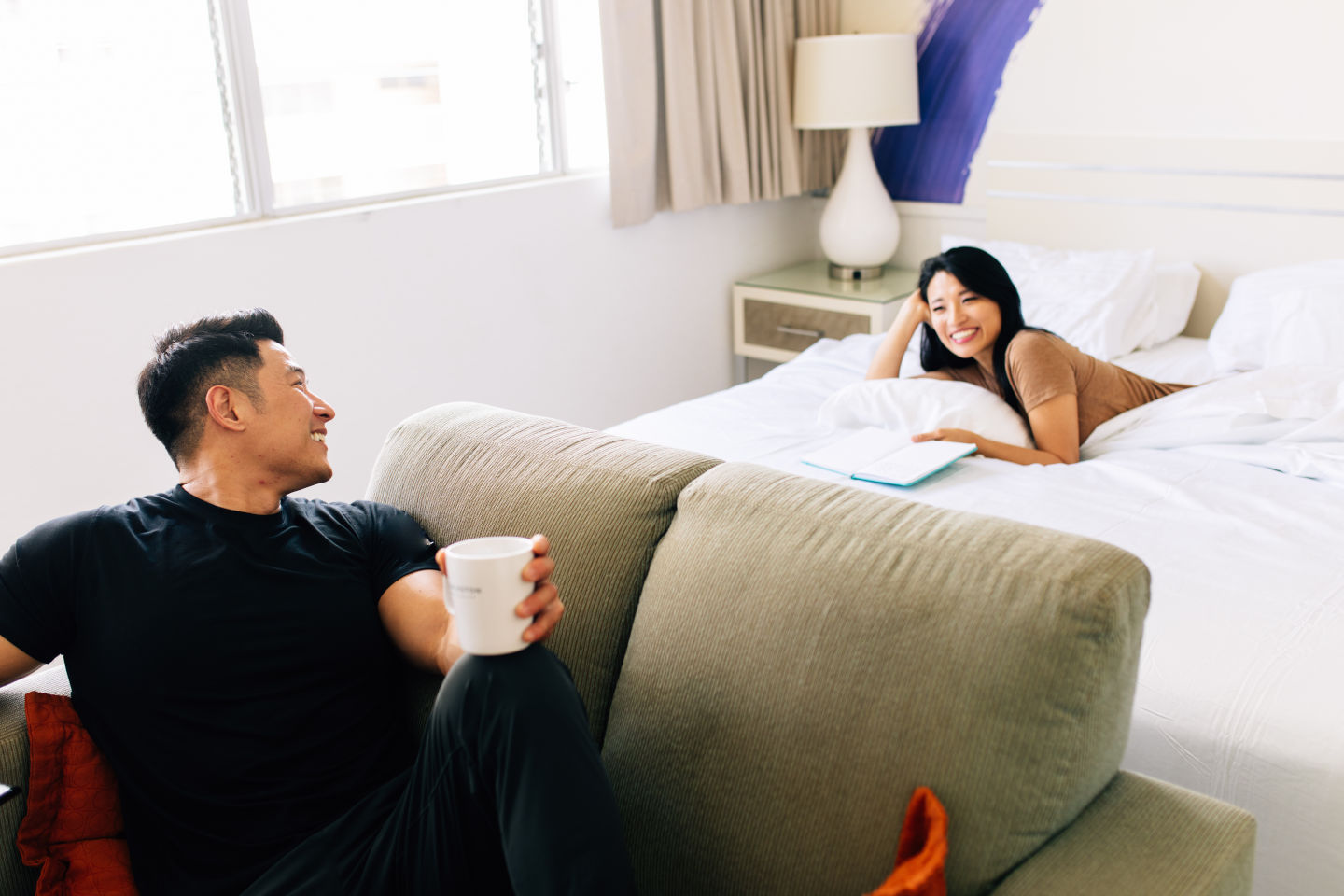 Couple lounging on bed and couch