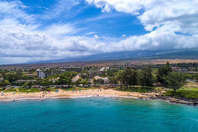 Aerial view of resort, mountains, and beachfront