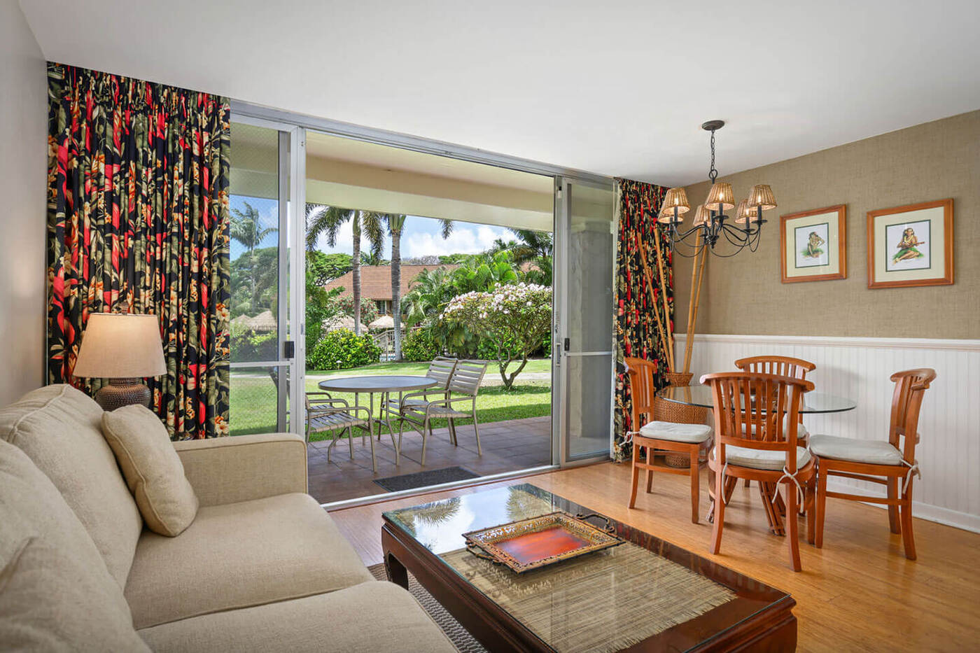 Living area with dining table, chairs, lamp, couch, coffee table, balcony