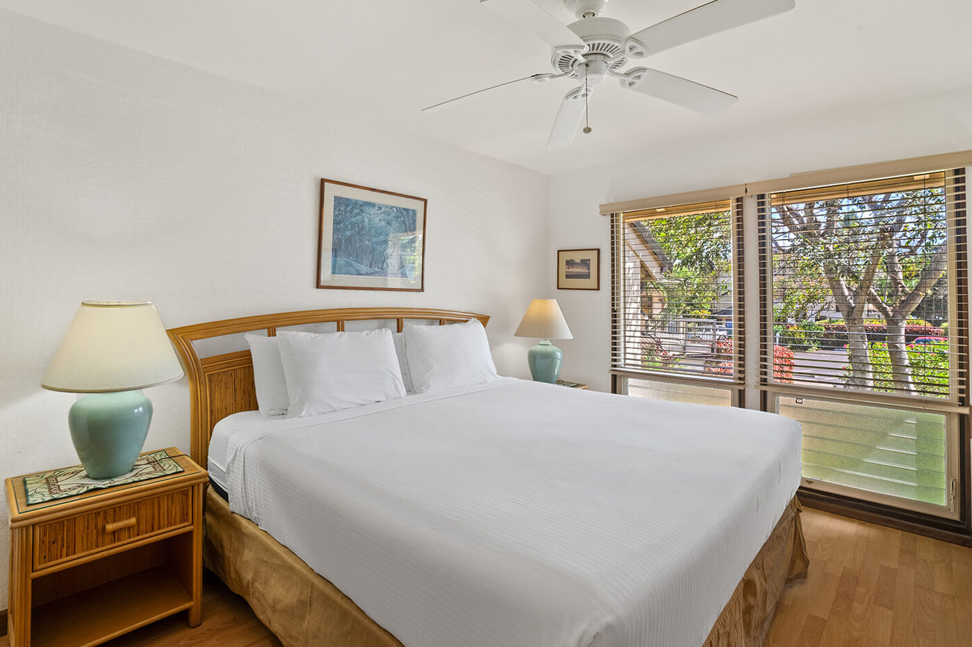 Room with bed, dresser, lamp, balcony.